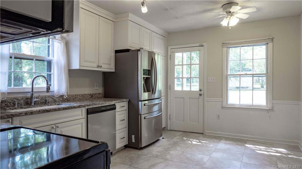 1708 Lawton Bluff Road Charlotte, NC 28226 - Photo 11 of 25 a kitchen with stainless steel appliances granite countertop a refrigerator a sink a stove and a microwave