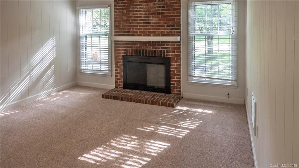 1708 Lawton Bluff Road Charlotte, NC 28226 - Photo 12 of 25 a view of empty room with fireplace and windows