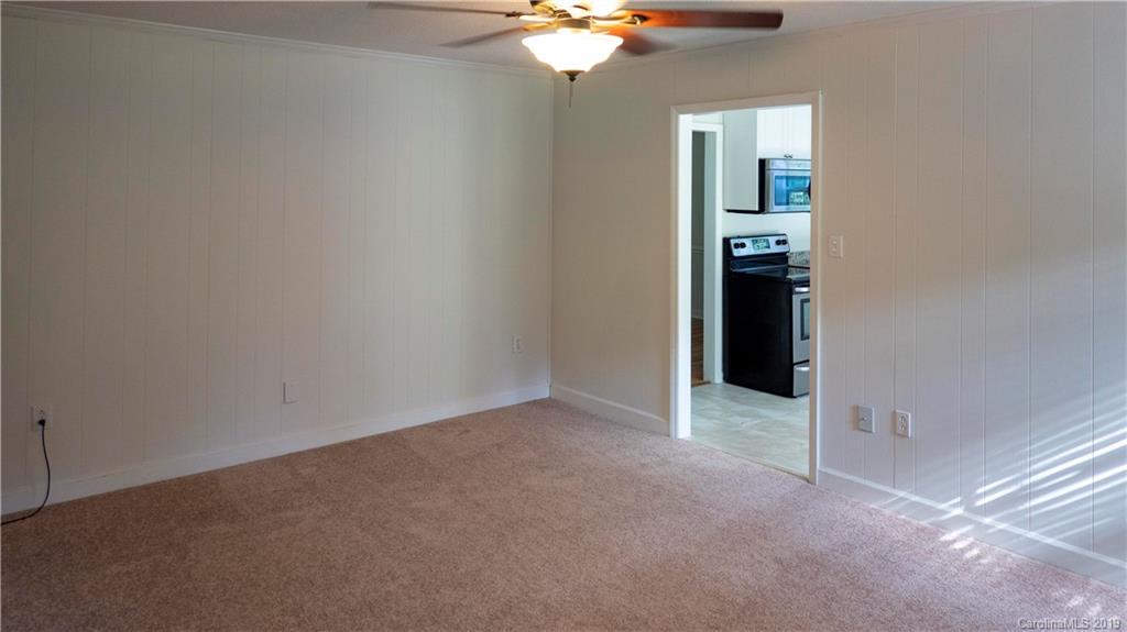 1708 Lawton Bluff Road Charlotte, NC 28226 - Photo 16 of 25 a view of an empty room with a chandelier fan