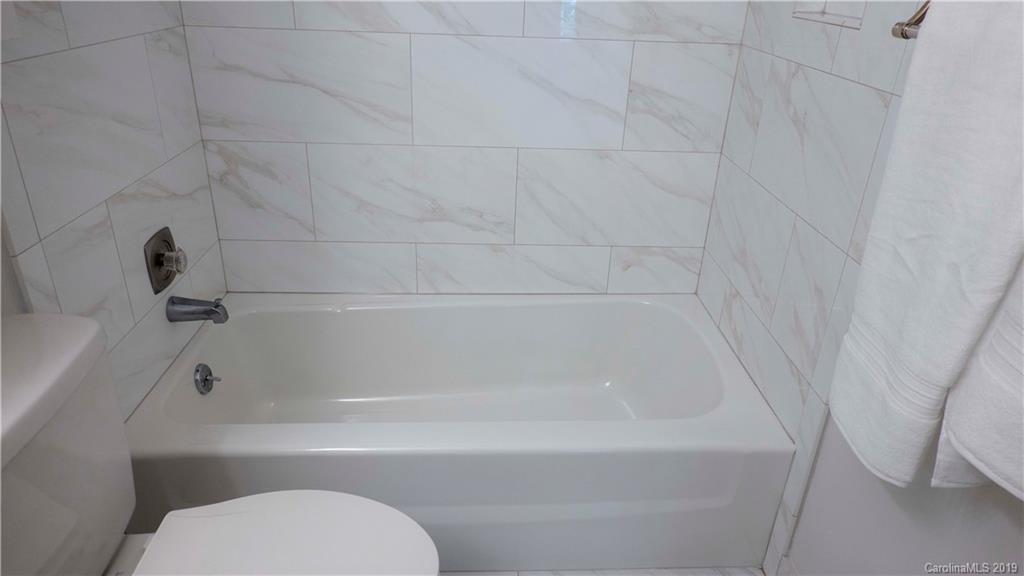 1708 Lawton Bluff Road Charlotte, NC 28226 - Photo 20 of 25 a bathroom with a toilet and bathtub