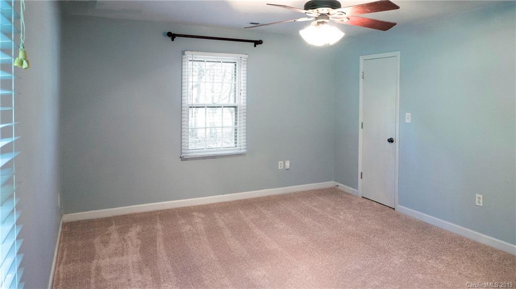 1708 Lawton Bluff Road Charlotte, NC 28226 - Photo 22 of 25 an empty room with a window and a chandelier fan