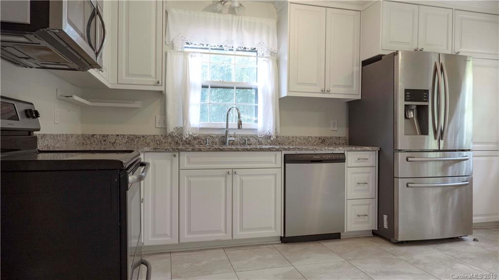 1708 Lawton Bluff Road Charlotte, NC 28226 - Photo 9 of 25 a kitchen with stainless steel appliances granite countertop a refrigerator and a stove