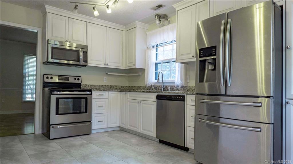 1708 Lawton Bluff Road Charlotte, NC 28226 - Photo 10 of 25 a kitchen with stainless steel appliances granite countertop a refrigerator stove and microwave