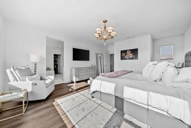 a view of a hallway with workspace and wooden floor