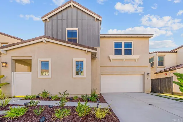 a front view of a house with a yard and outdoor seating