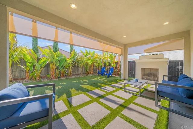an aerial view of a residential apartment building with swimming pool and lawn chairs