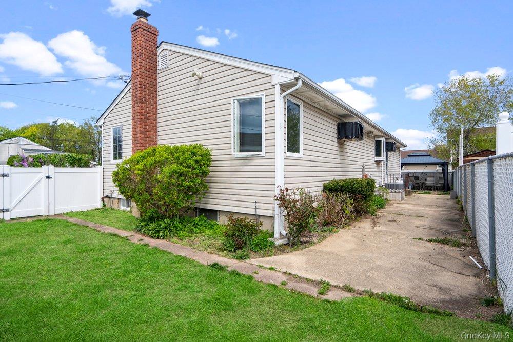 101 Sexton Road West Babylon, NY 11704 - Photo 28 of 33 a front view of a house with a yard and potted plants
