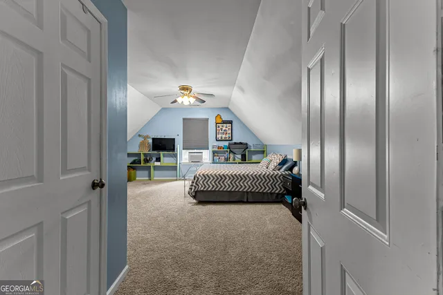 a bedroom with a bed and a mirror