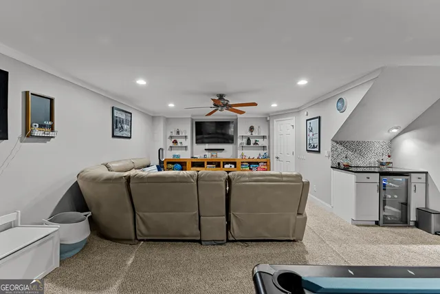 a living room with furniture and kitchen view