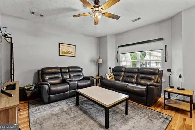 a living room with furniture a rug and a window