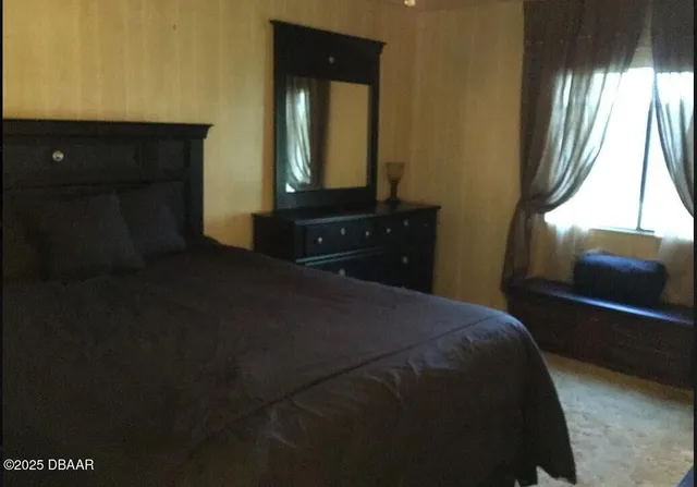 a bedroom with a bed and a mirror