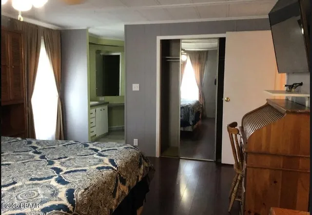 a bedroom with a bed and a mirror
