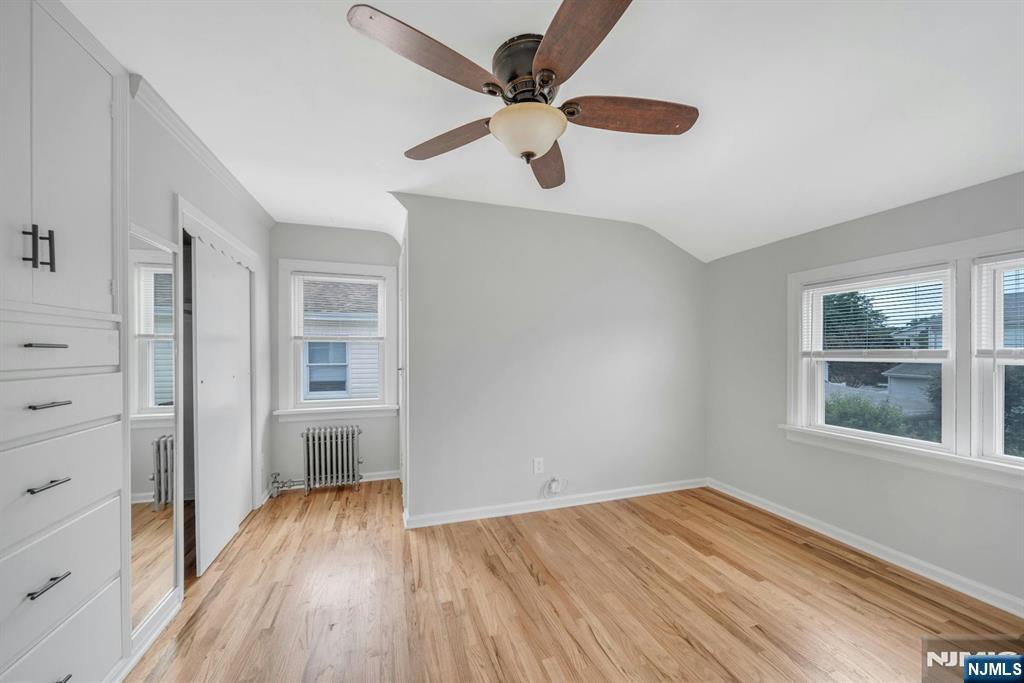 88 McKinley Avenue, Unit 2 Lodi, NJ 07644 - Photo 6 of 10 wooden floor in an empty room with a window