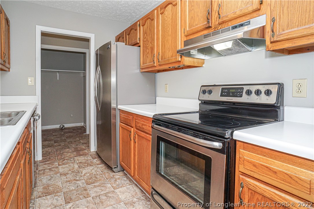 5094 Summer Ridge Road Fayetteville, NC 28303 - Photo 11 of 30 a kitchen with stainless steel appliances granite countertop a stove and a refrigerator