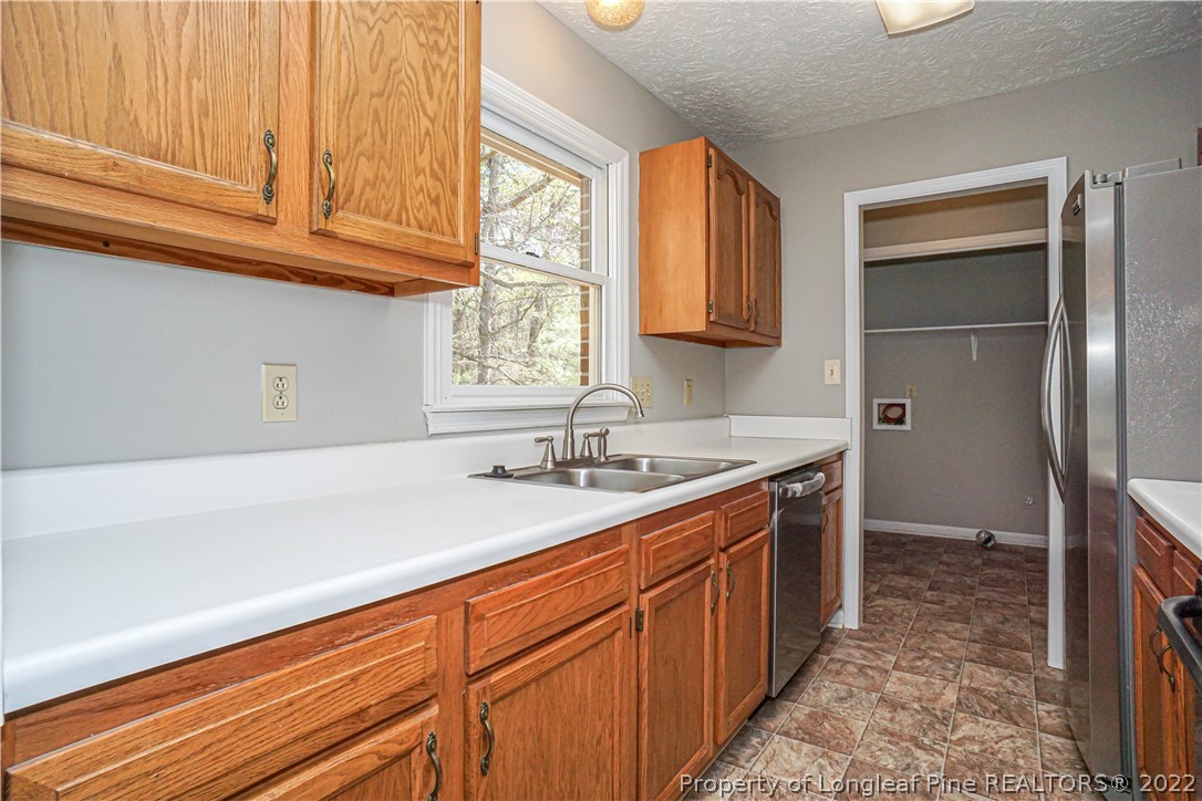 5094 Summer Ridge Road Fayetteville, NC 28303 - Photo 12 of 30 a kitchen with stainless steel appliances granite countertop a sink stove and refrigerator