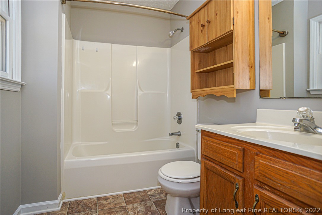 5094 Summer Ridge Road Fayetteville, NC 28303 - Photo 26 of 30 a bathroom with a sink a toilet and shower