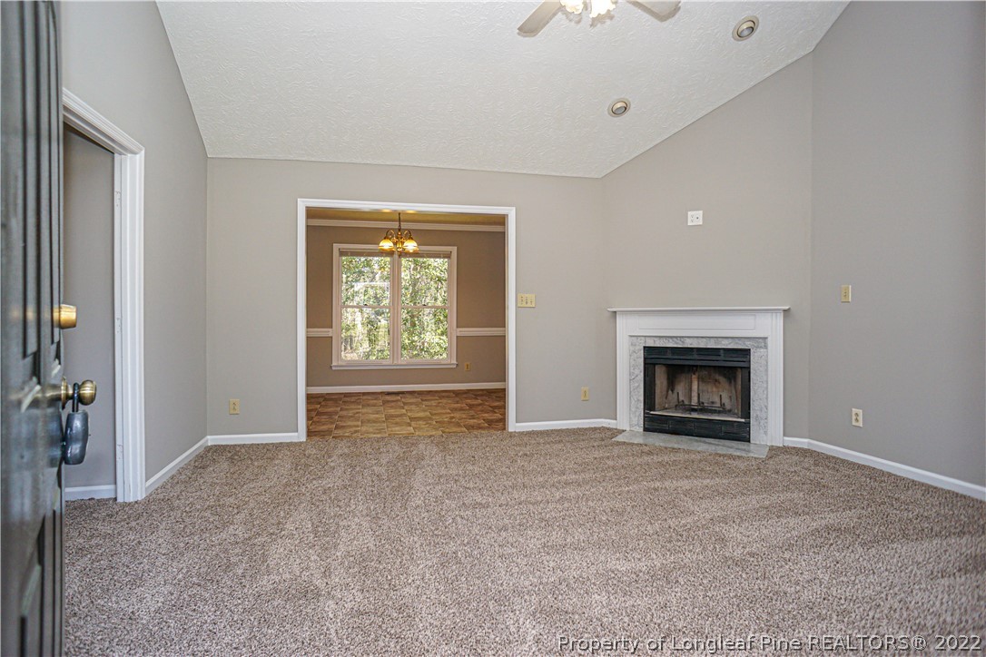 5094 Summer Ridge Road Fayetteville, NC 28303 - Photo 3 of 30 an empty room with windows and fireplace