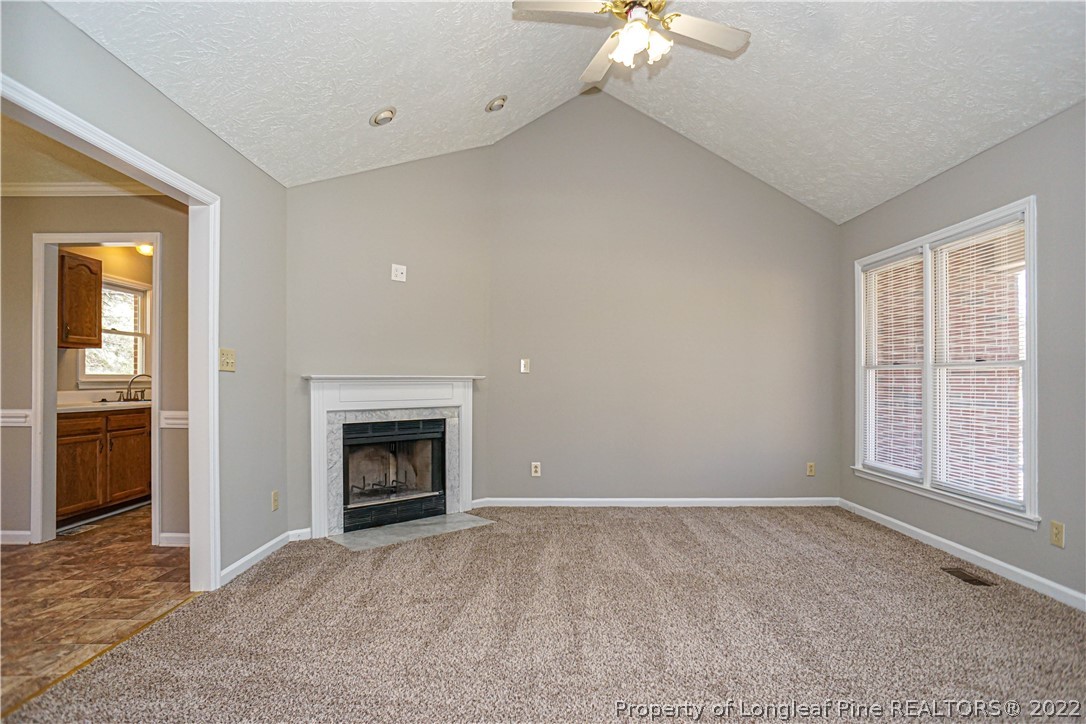 5094 Summer Ridge Road Fayetteville, NC 28303 - Photo 4 of 30 wooden floor fireplace and windows in an empty room