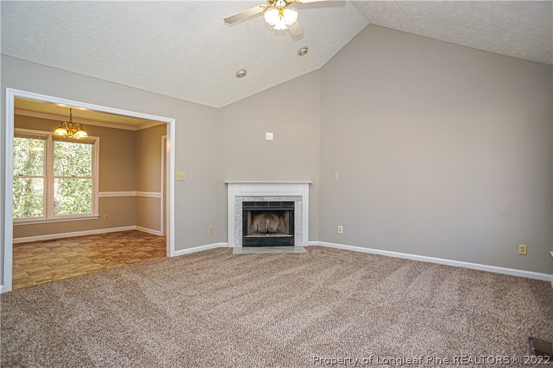 5094 Summer Ridge Road Fayetteville, NC 28303 - Photo 5 of 30 an empty room with a fireplace and a window