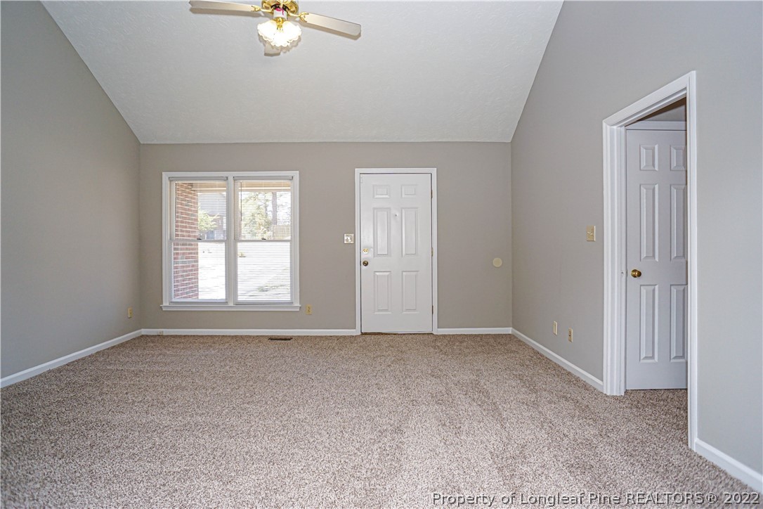 5094 Summer Ridge Road Fayetteville, NC 28303 - Photo 7 of 30 an empty room with chandelier fan and windows