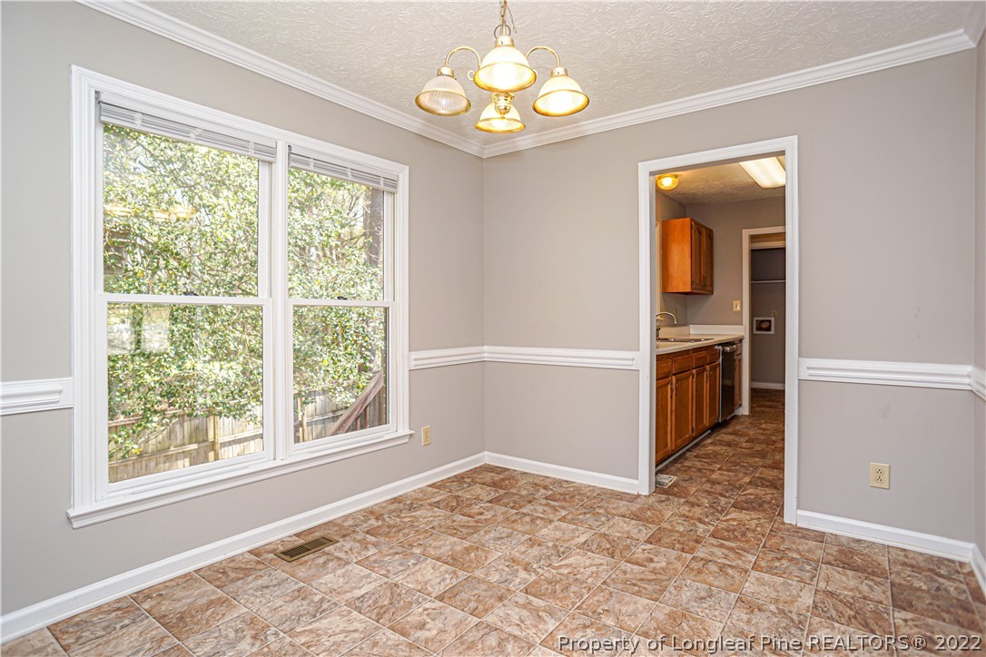 5094 Summer Ridge Road Fayetteville, NC 28303 - Photo 9 of 30 an empty room with windows and ceiling fan