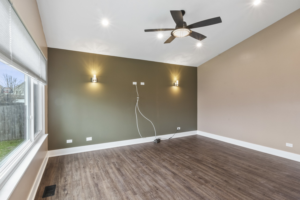 25782 West Prairieview Road Round Lake, IL 60073 - Photo 12 of 34 an empty room with wooden floor and windows
