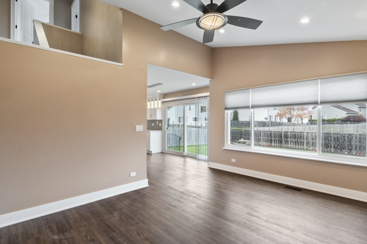 25782 West Prairieview Road Round Lake, IL 60073 - Photo 13 of 34 an empty room with wooden floor and windows