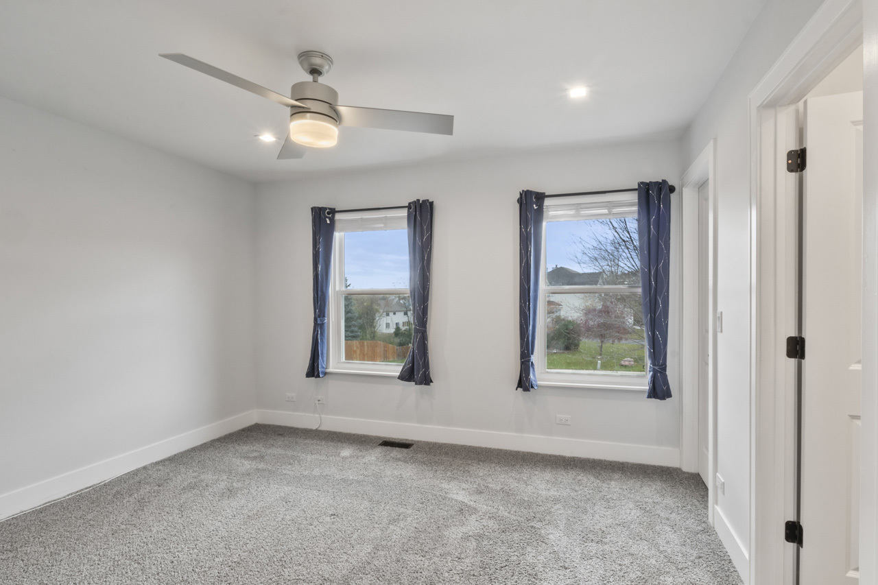 25782 West Prairieview Road Round Lake, IL 60073 - Photo 17 of 34 an empty room with windows and fan