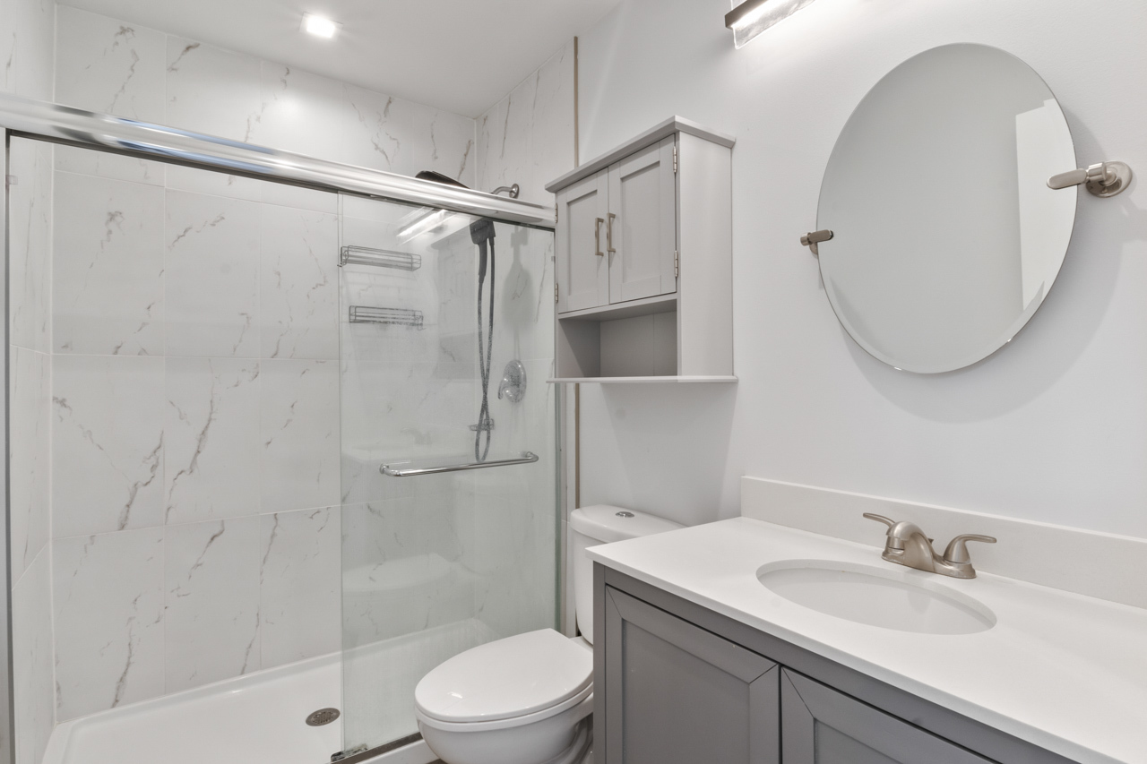 25782 West Prairieview Road Round Lake, IL 60073 - Photo 19 of 34 a bathroom with a granite countertop sink toilet a mirror and shower