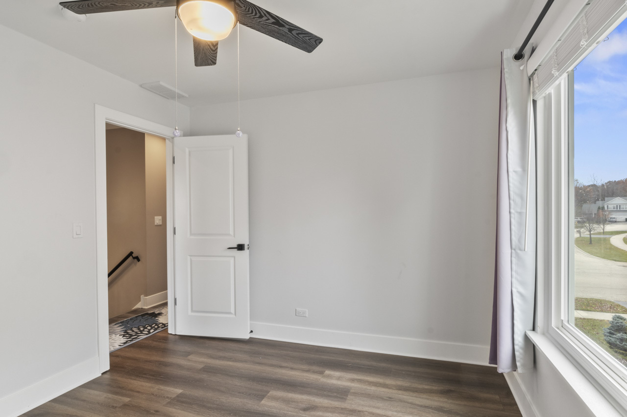 25782 West Prairieview Road Round Lake, IL 60073 - Photo 22 of 34 a view of an empty room with wooden floor and a window