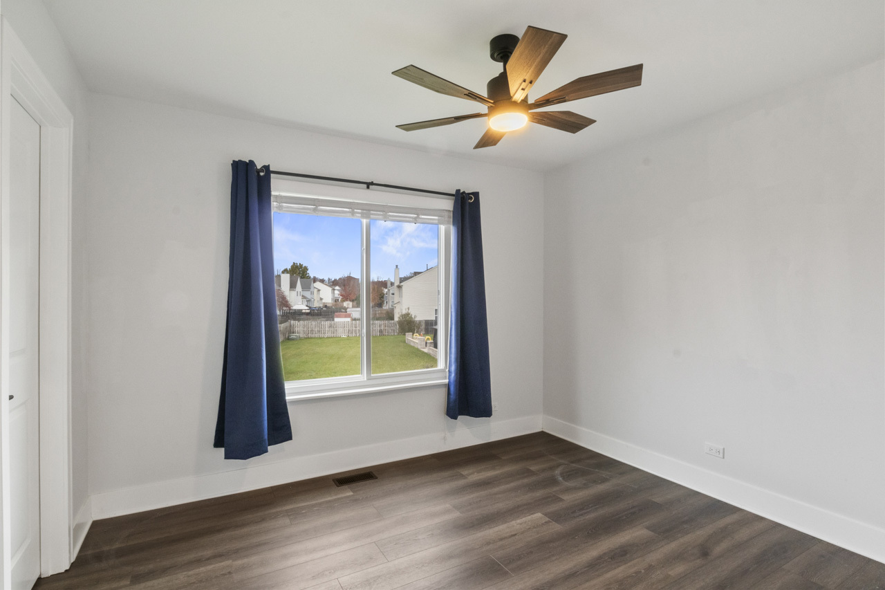 25782 West Prairieview Road Round Lake, IL 60073 - Photo 23 of 34 an empty room with wooden floor and windows