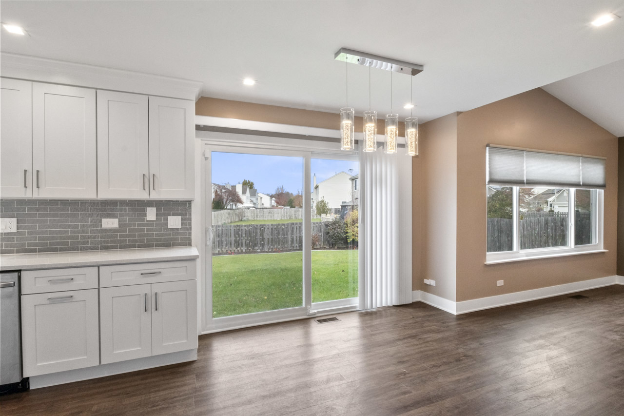 25782 West Prairieview Road Round Lake, IL 60073 - Photo 6 of 34 a view of a kitchen with a dishwasher cabinets and a floor to ceiling window