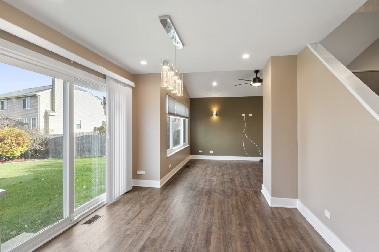 25782 West Prairieview Road Round Lake, IL 60073 - Photo 10 of 34 a view of a big room with wooden floor and windows
