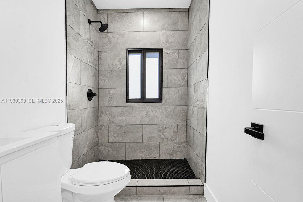 3040 Northwest 13th Avenue Miami, FL 33142 - Photo 11 of 46 a bathroom with a toilet and a shower