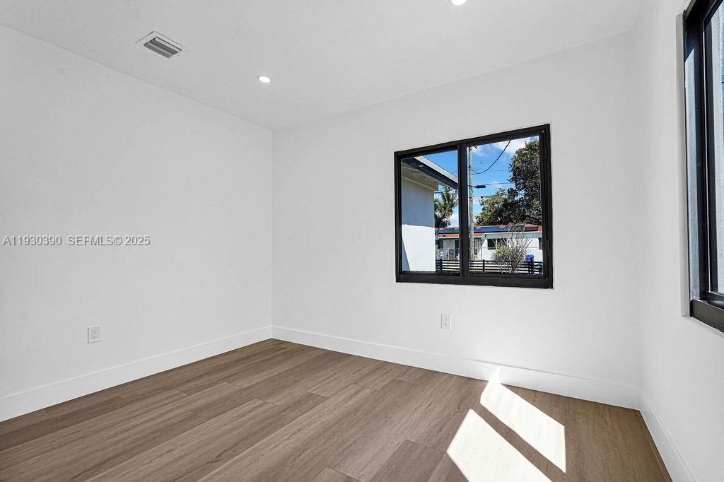 3040 Northwest 13th Avenue Miami, FL 33142 - Photo 17 of 46 a view of a big room with wooden floor and windows