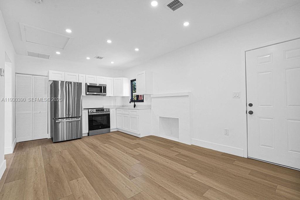 3040 Northwest 13th Avenue Miami, FL 33142 - Photo 20 of 46 a kitchen with stainless steel appliances a refrigerator and a stove top oven