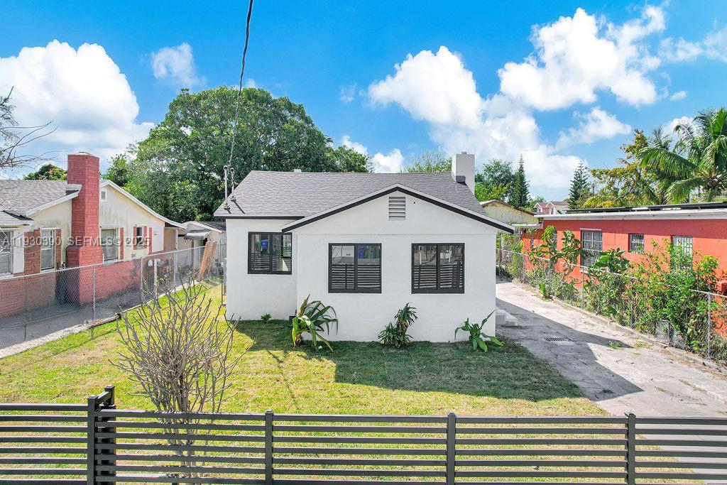 3040 Northwest 13th Avenue Miami, FL 33142 - Photo 2 of 46 a front view of a house with garden