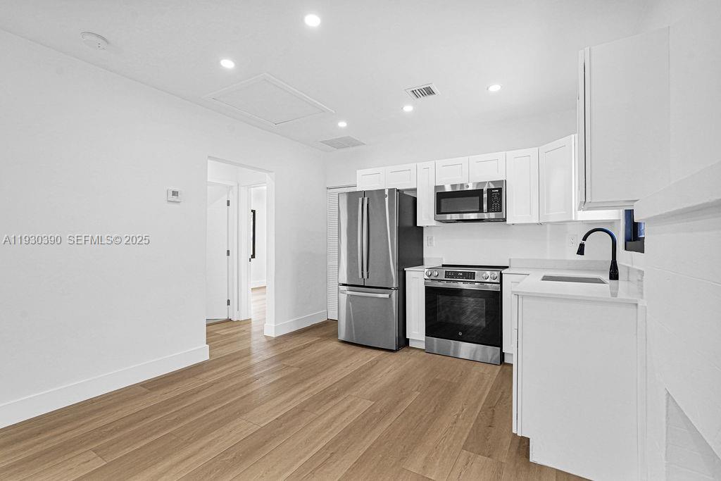 3040 Northwest 13th Avenue Miami, FL 33142 - Photo 30 of 46 a kitchen with a refrigerator stove and a sink