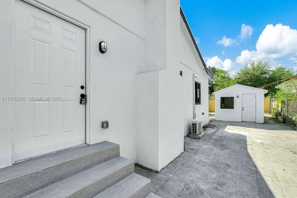 3040 Northwest 13th Avenue Miami, FL 33142 - Photo 46 of 46 a view of a house with backyard and a garage