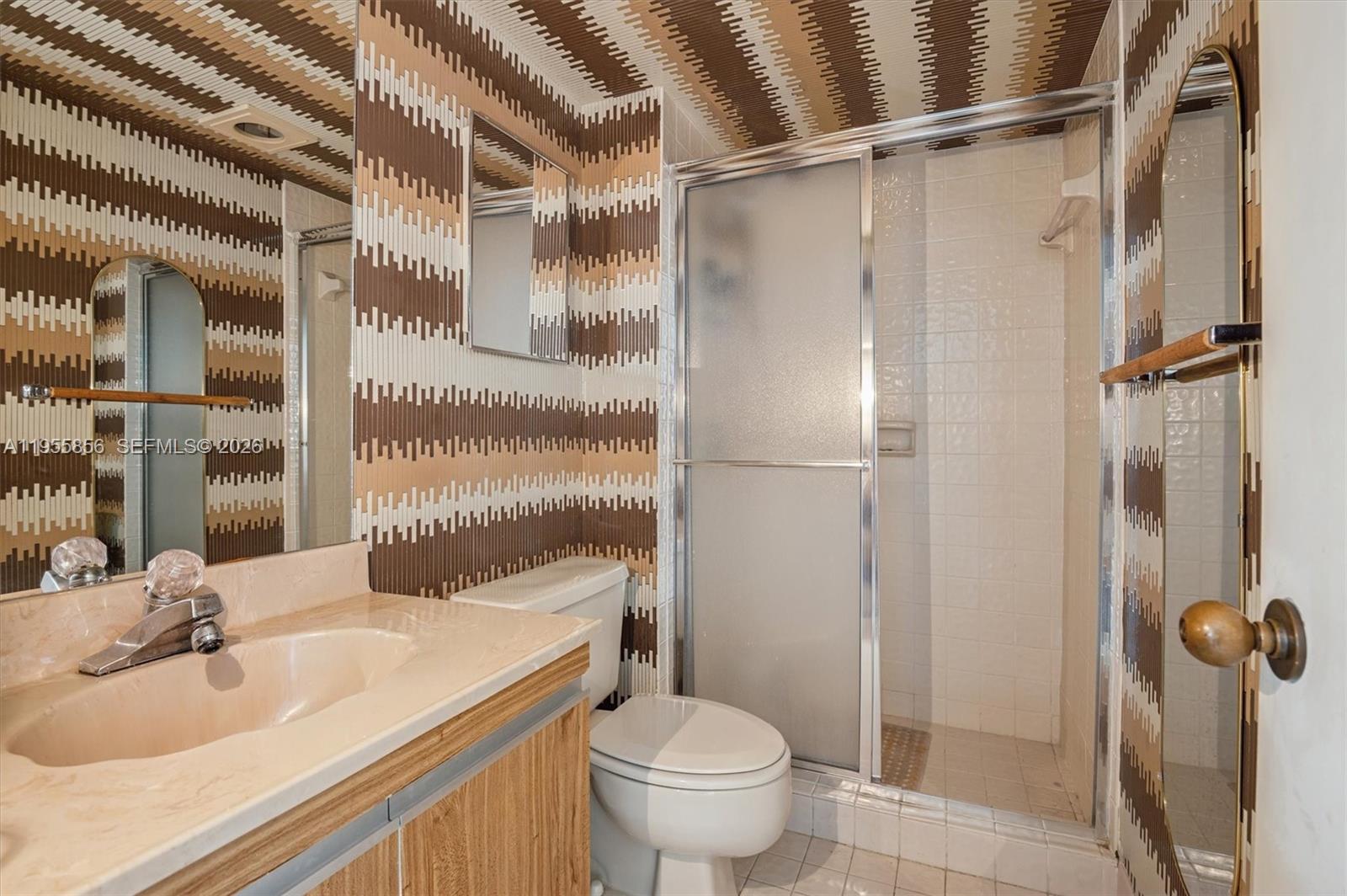 4301 Collins Avenue, Unit 202 Miami Beach, FL 33140 - Photo 11 of 12 a bathroom with a sink toilet and shower