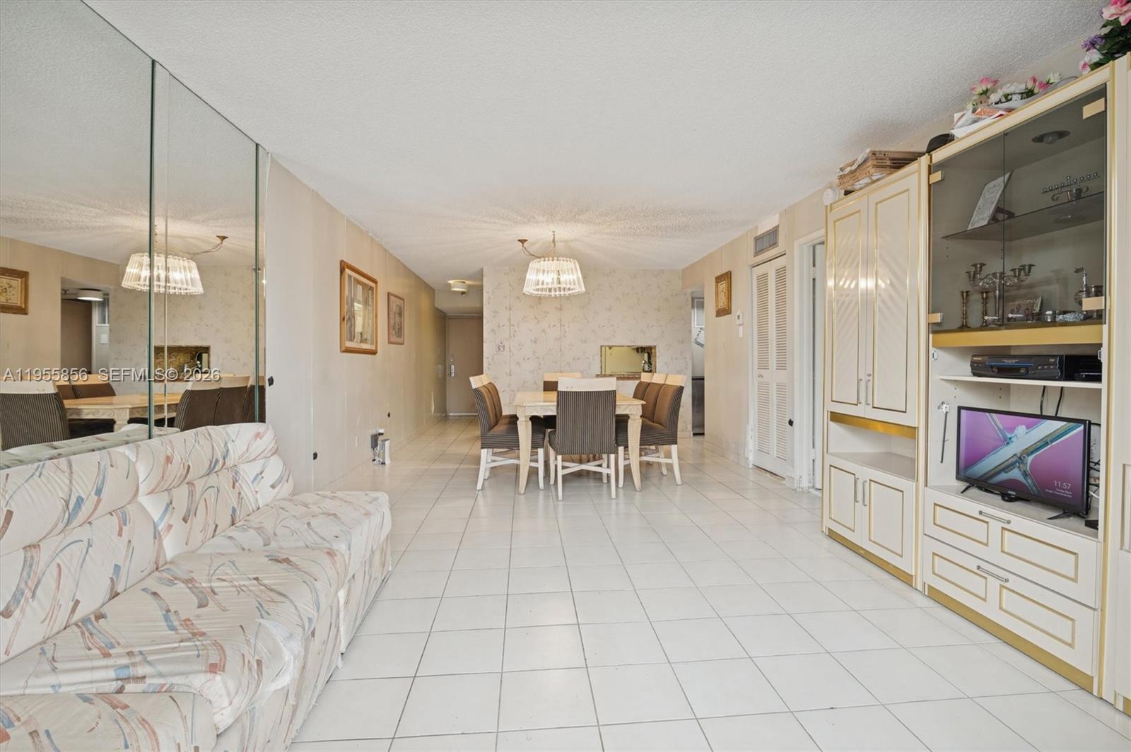 4301 Collins Avenue, Unit 202 Miami Beach, FL 33140 - Photo 6 of 12 a living room with furniture and a flat screen tv