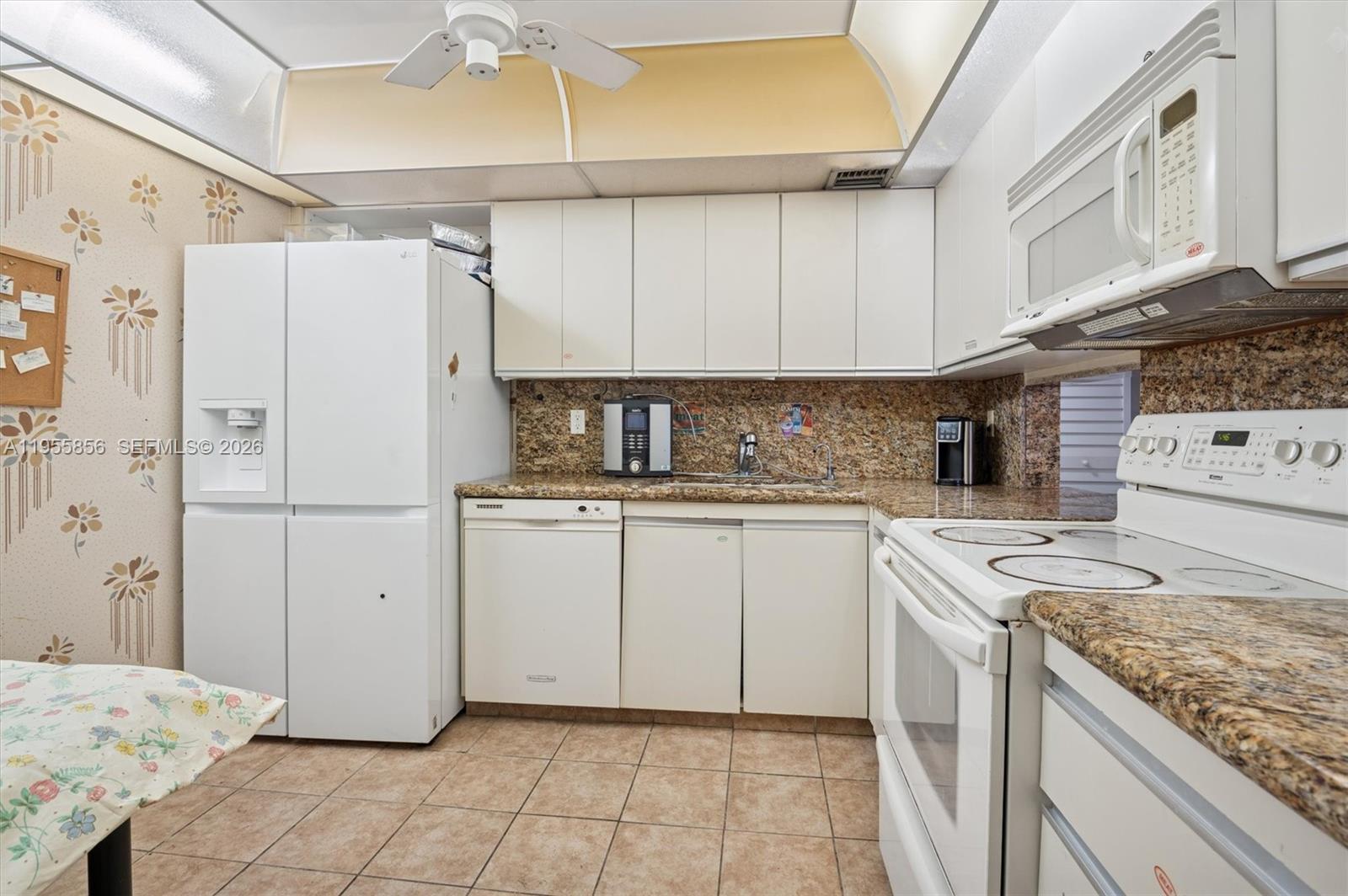 4301 Collins Avenue, Unit 202 Miami Beach, FL 33140 - Photo 7 of 12 a kitchen with appliances cabinets and a sink