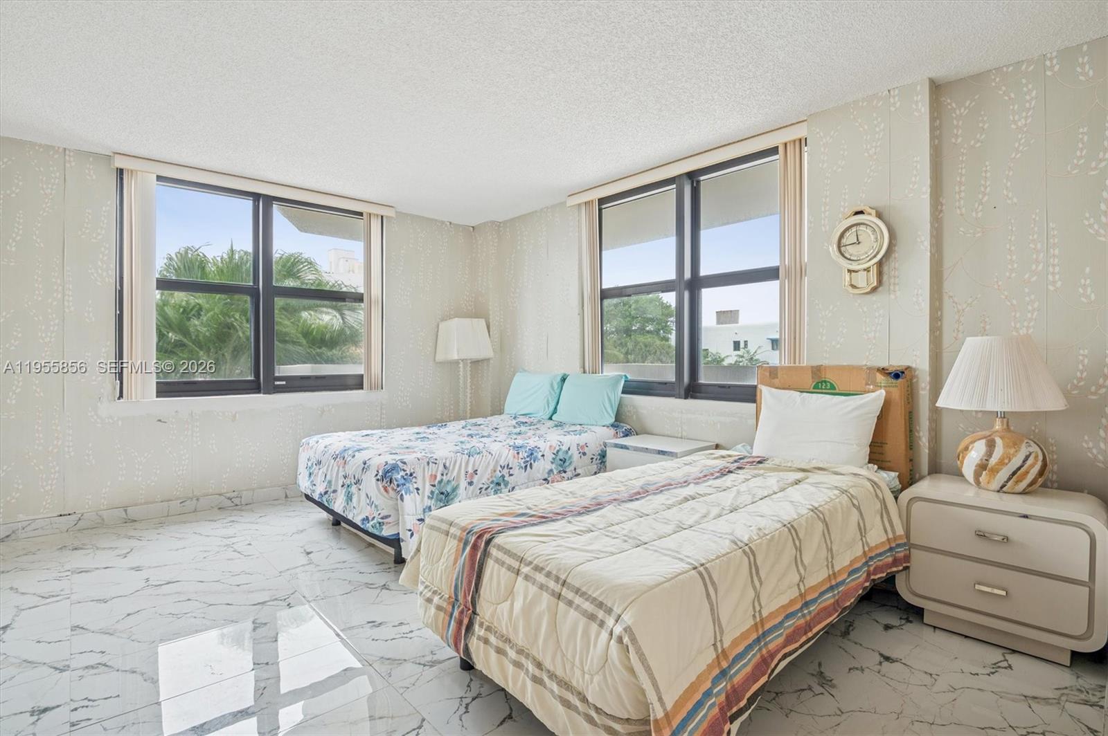 4301 Collins Avenue, Unit 202 Miami Beach, FL 33140 - Photo 8 of 12 a bedroom with two beds and a large window
