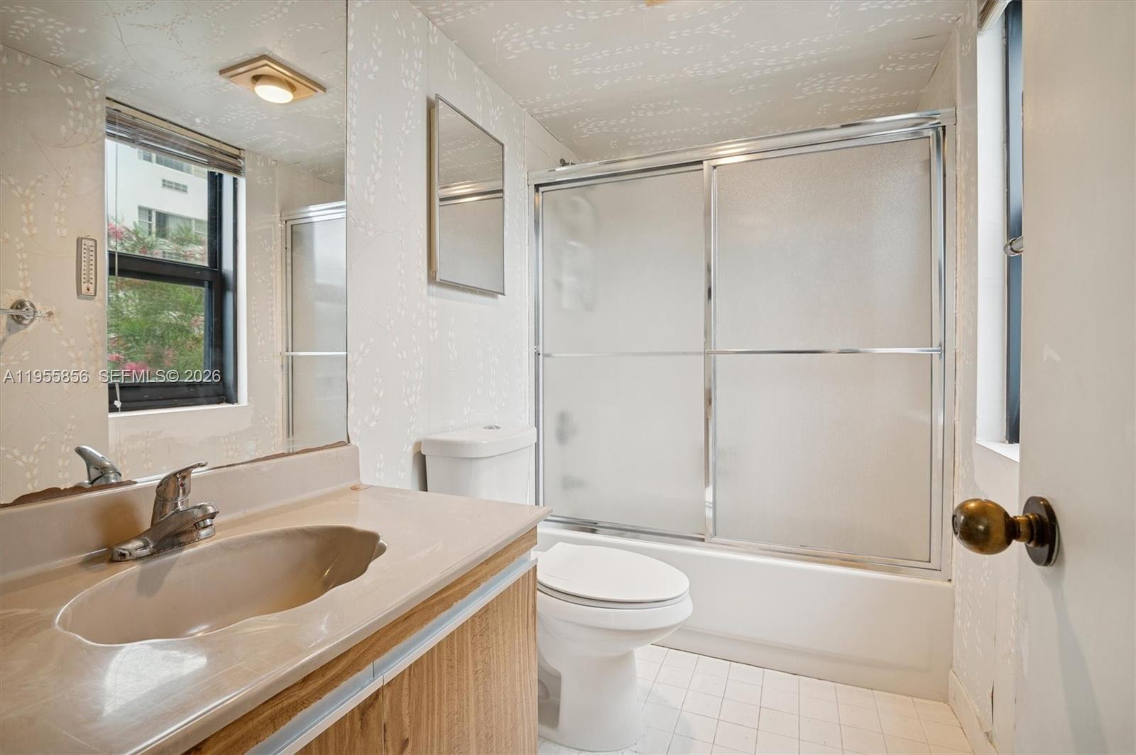 4301 Collins Avenue, Unit 202 Miami Beach, FL 33140 - Photo 9 of 12 a bathroom with a sink a toilet and shower