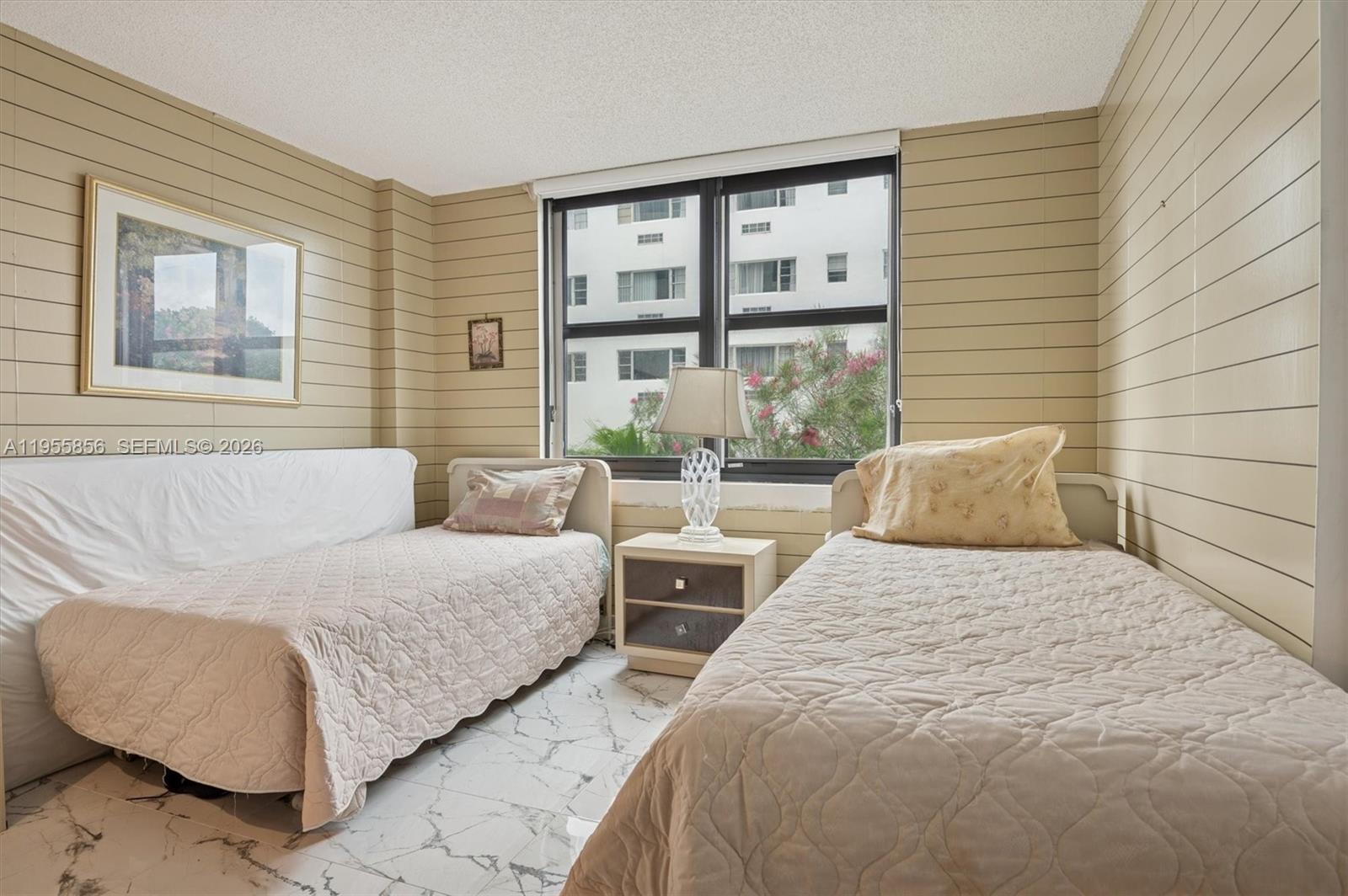 4301 Collins Avenue, Unit 202 Miami Beach, FL 33140 - Photo 10 of 12 a bedroom with two beds and large window