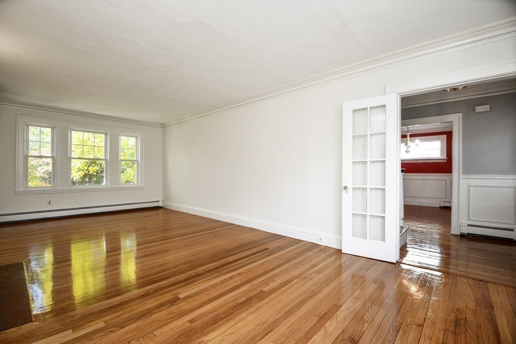 121 Lovell Road Watertown, MA 02472 - Photo 5 of 22 a view of empty room with wooden floor and fan