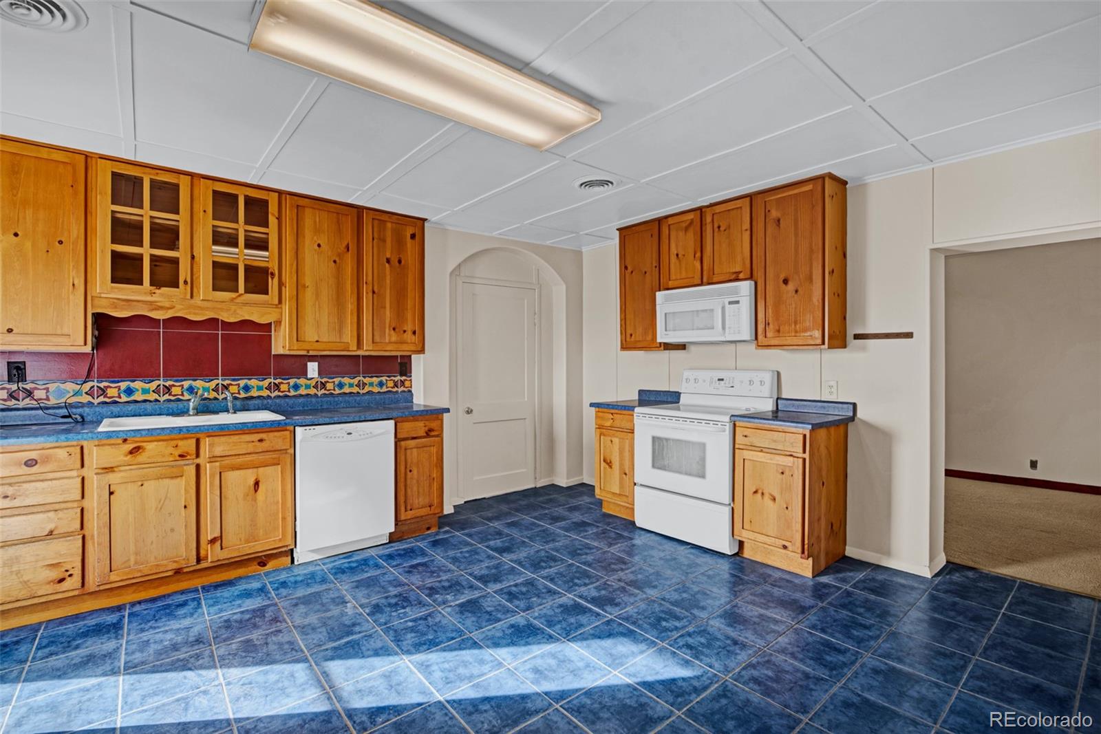 711 Front Street Fairplay, CO 80440 - Photo 9 of 40 a kitchen with stainless steel appliances granite countertop a stove a sink and a refrigerator