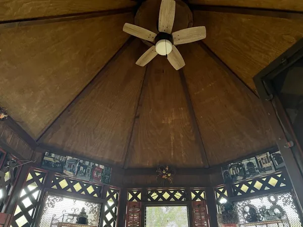 a view of a kitchen with refrigerator and wooden floor
