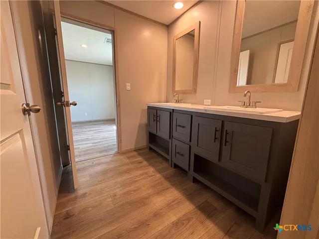 a bathroom with a double vanity sink and mirror