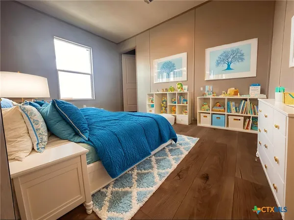a bed sitting in a bedroom next to a window
